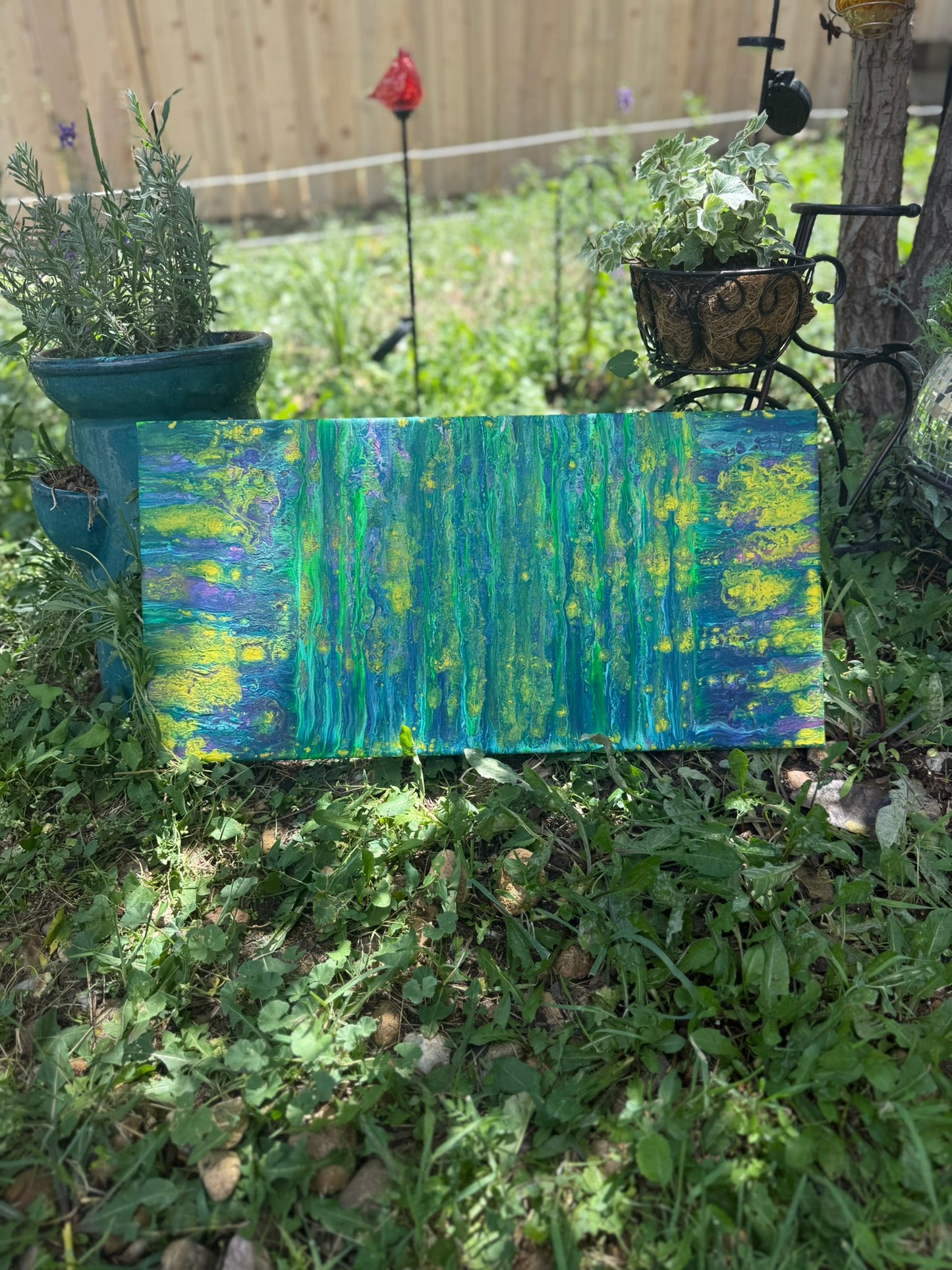 Colorful abstract painting in a garden setting