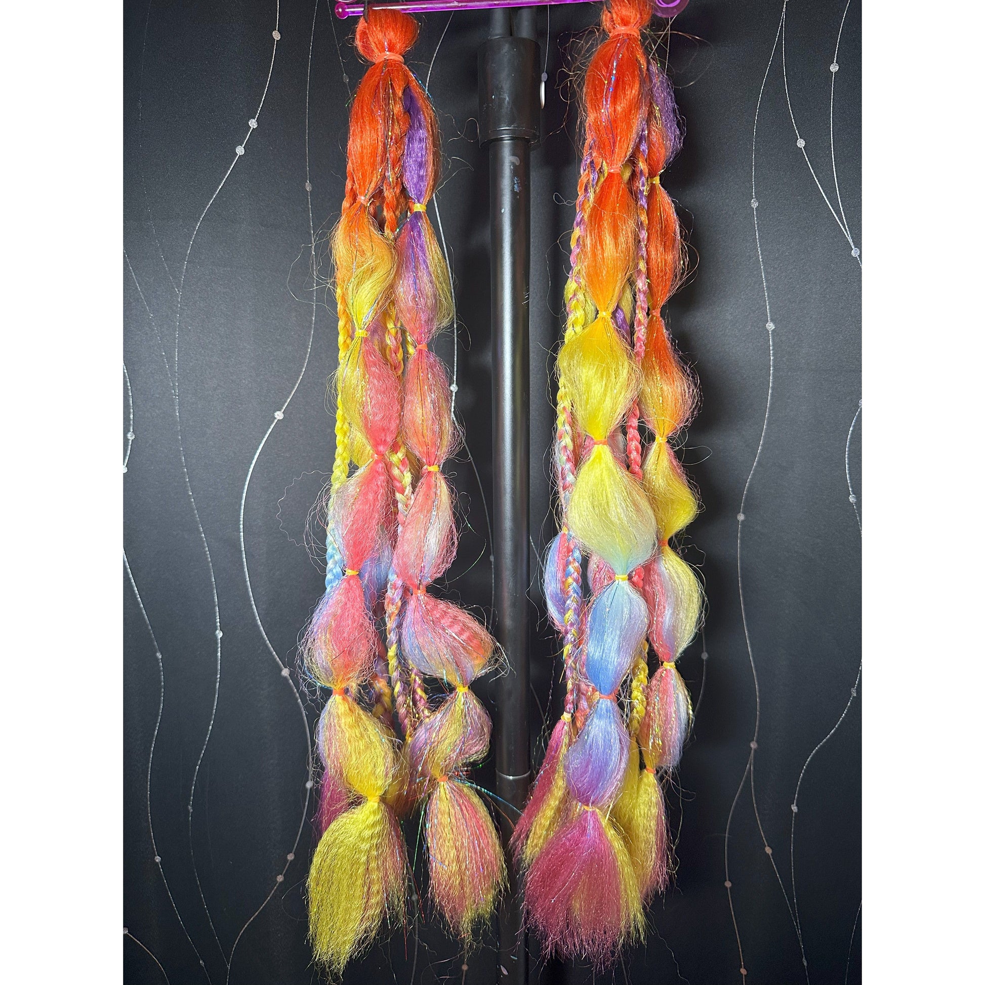 This handmade set by Jessica is 22 inches long, 7 pieces per pony, 2 ponytails - Orange, Purple, Coral, Light Blue, Pink & Neon Yellow ombre hair with multicolor tinsel. Each pony has braids, twists and bubbles! Used once, simply run straightener over the wavy parts and mold bubbles as you desire