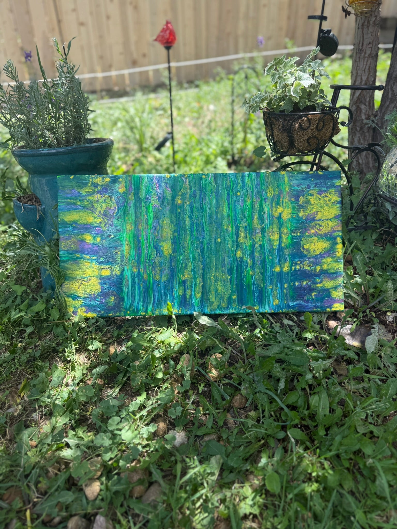 Colorful abstract painting in a garden setting